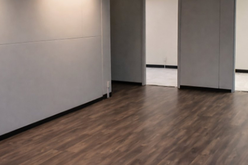 Empty ground-floor suite interior with wood-look flooring at 620 Peachtree St NE